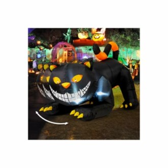 Inflatable black cat Halloween decoration with glowing eyes and pumpkins in the background.