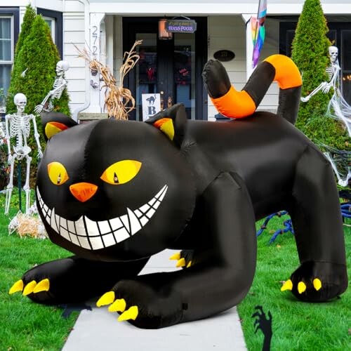 Inflatable black cat with a mischievous grin on a lawn, surrounded by Halloween decorations.