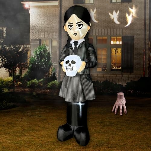 Inflatable Halloween decoration of a character holding a skull in a yard.