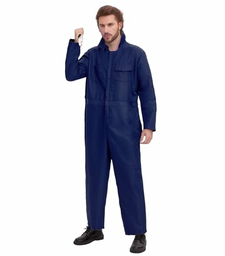 Man wearing blue coveralls holding a tool