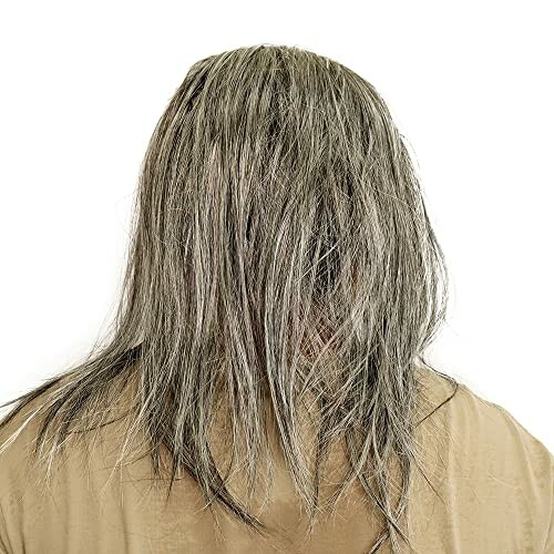 Person with long hair covering their face, wearing a beige shirt.