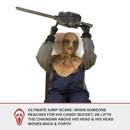 Scarecrow figure holding a chainsaw above its head.