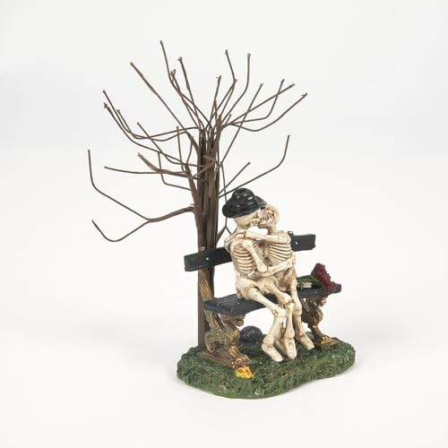 Two skeletons sitting on a bench under a bare tree