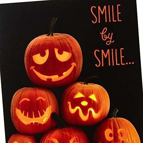 Stacked pumpkins with carved smiling faces and 'Smile by Smile' text.