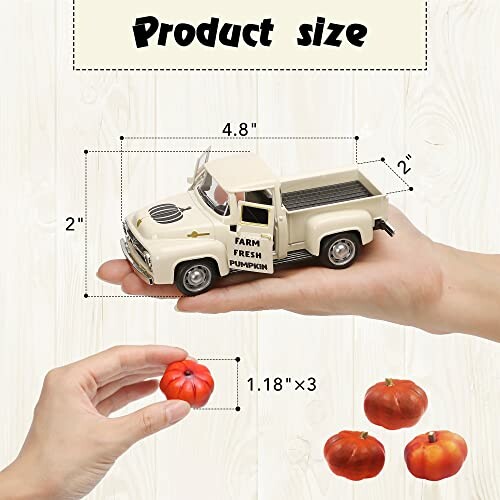 Hand holding a small vintage truck with farm fresh pumpkin text and mini pumpkins.